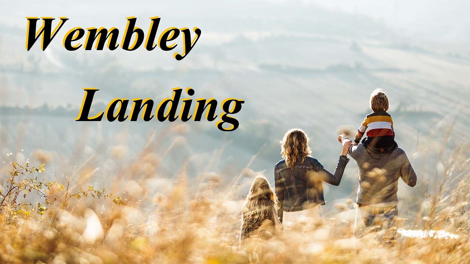 Family of three walking through tall grass.